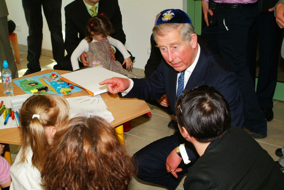 Prince Charles speaking animatedly to Jewish children in Krakow